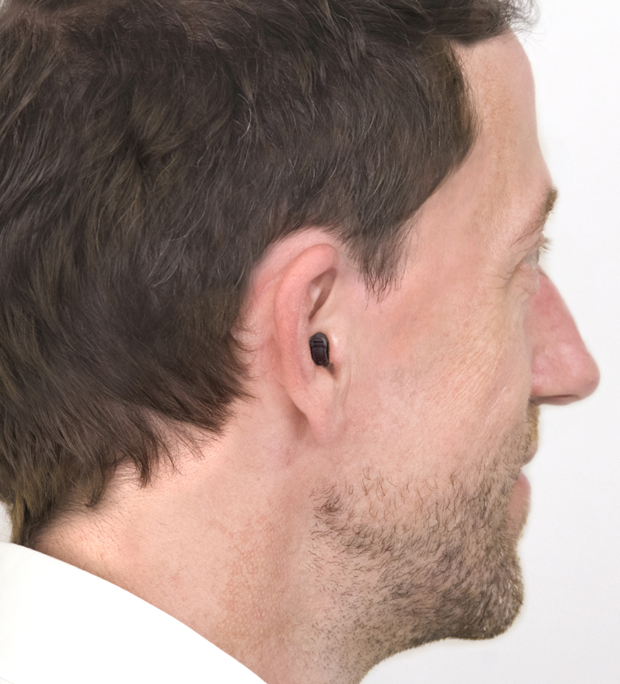 woman showing a Completely-in-Canal (CIC) style hearing aid