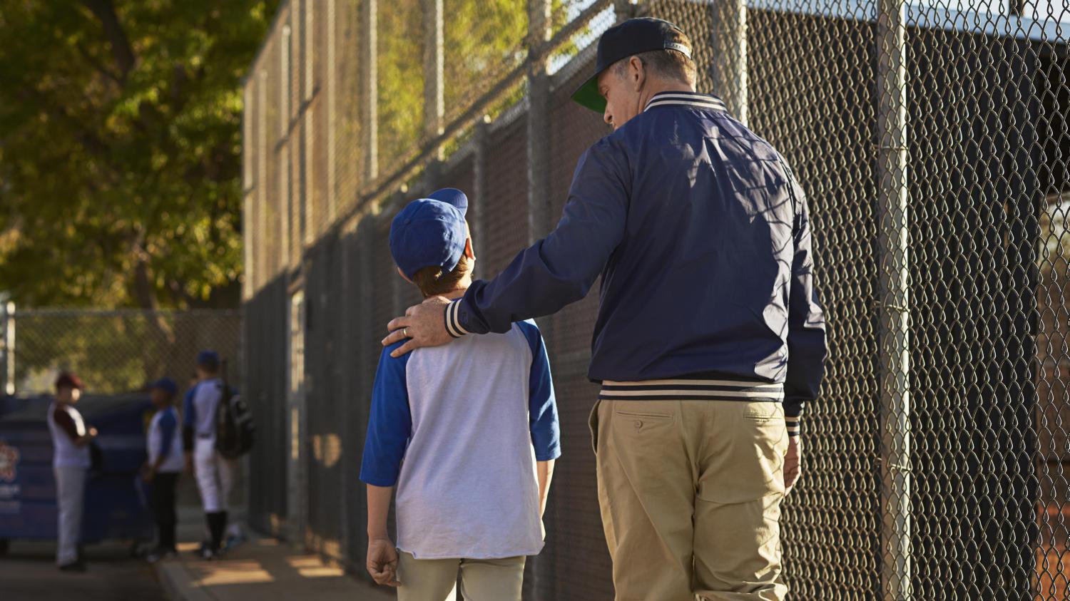 Coach wearing hearing aids talks to happy kid