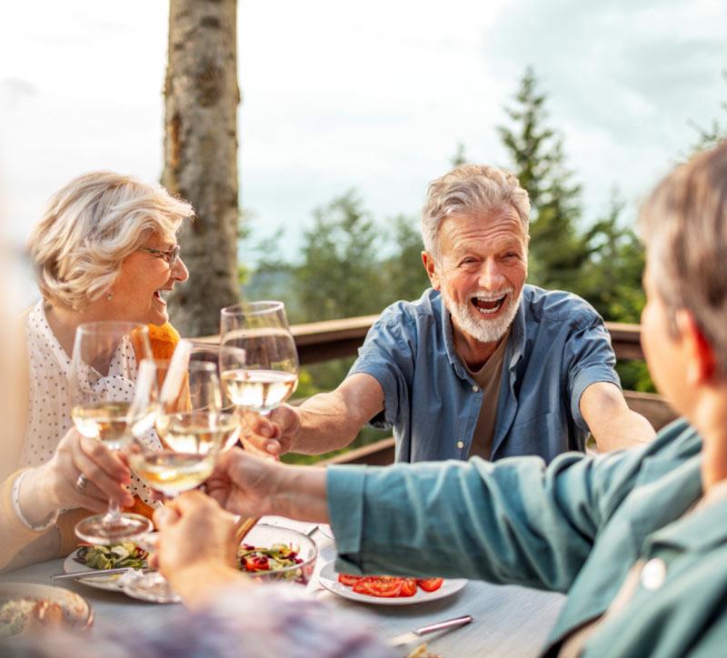 Men wearing the essential hearing aids and enjoy the outdoor party with friends and family