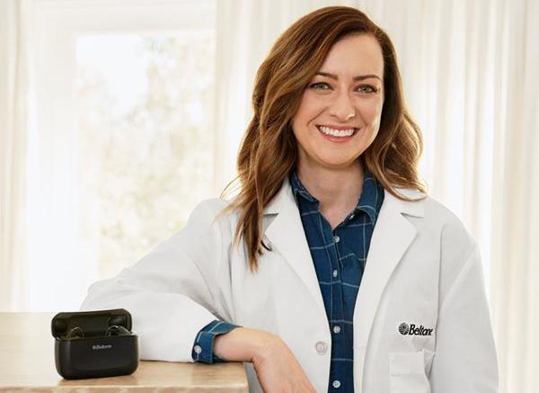Beltone hearing care professional with Beltone Amaze hearing aid