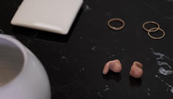 Discreet, practically invisible ReSound Key hearing aids on a table
