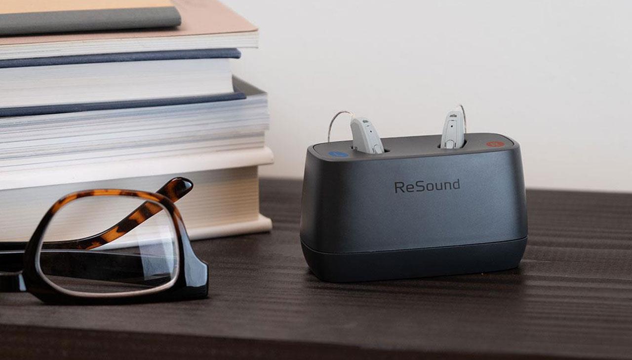 ReSound Key rechargeable RIE hearing aids in a charger