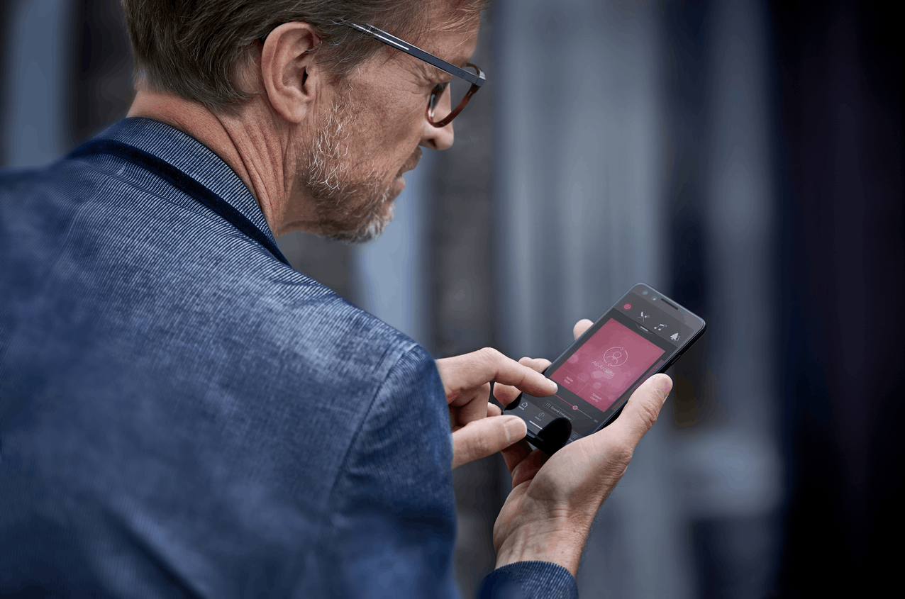 Man holding bluetooth hearing aid Android